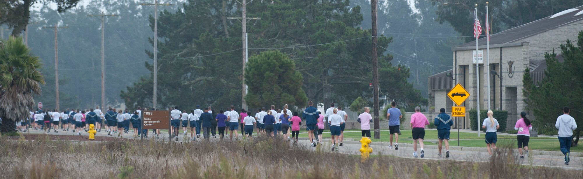 VANDENBERG AIR FORCE BASE, Calif. – Team V runs along New Mexico Avenue during the wing run here Friday, Sept. 28, 2012. Base personnel were encouraged to wear pink or purple t-shirts in support of Breast Cancer and Domestic Violence Awareness Month. (U.S. Air Force photo by Senior Airman Lael Huss)