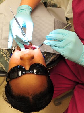 Senior Airman Amy Davey, dental assistant from the 92nd Aerospace Medicine Squadron, performs an annual checkup using a dental explorer, an instrument used for screening for periodontal disease, on Staff Sgt. Jasmine Phillips, member of the 92nd Aerospace Medicine Squadron at Fairchild Air Force Base, Wash., Sept. 28, 2012. (U.S. Air Force photo by Airman 1st Class Taylor Curry)