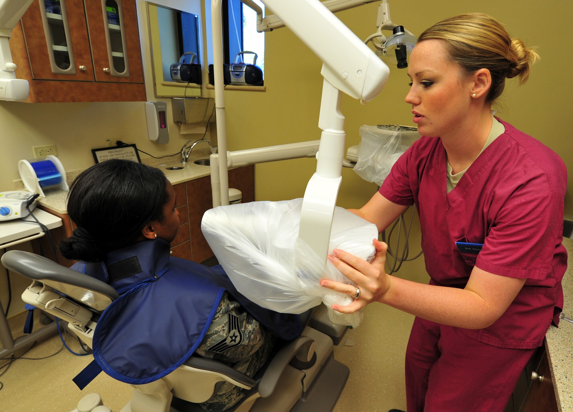 Senior Airman Amy Davey takes a bitewing x-ray on Staff Sgt. Jasmine Phillips, member of the 92nd Aerospace Medicine Squadron, during her annual dental exam at Fairchild Air Force Base, Wash., Sept. 28, 2012. Davey is a dental assistant from the 92nd Aerospace Medicine Squadron. (U.S. Air Force photo by Airman 1st Class Taylor Curry)