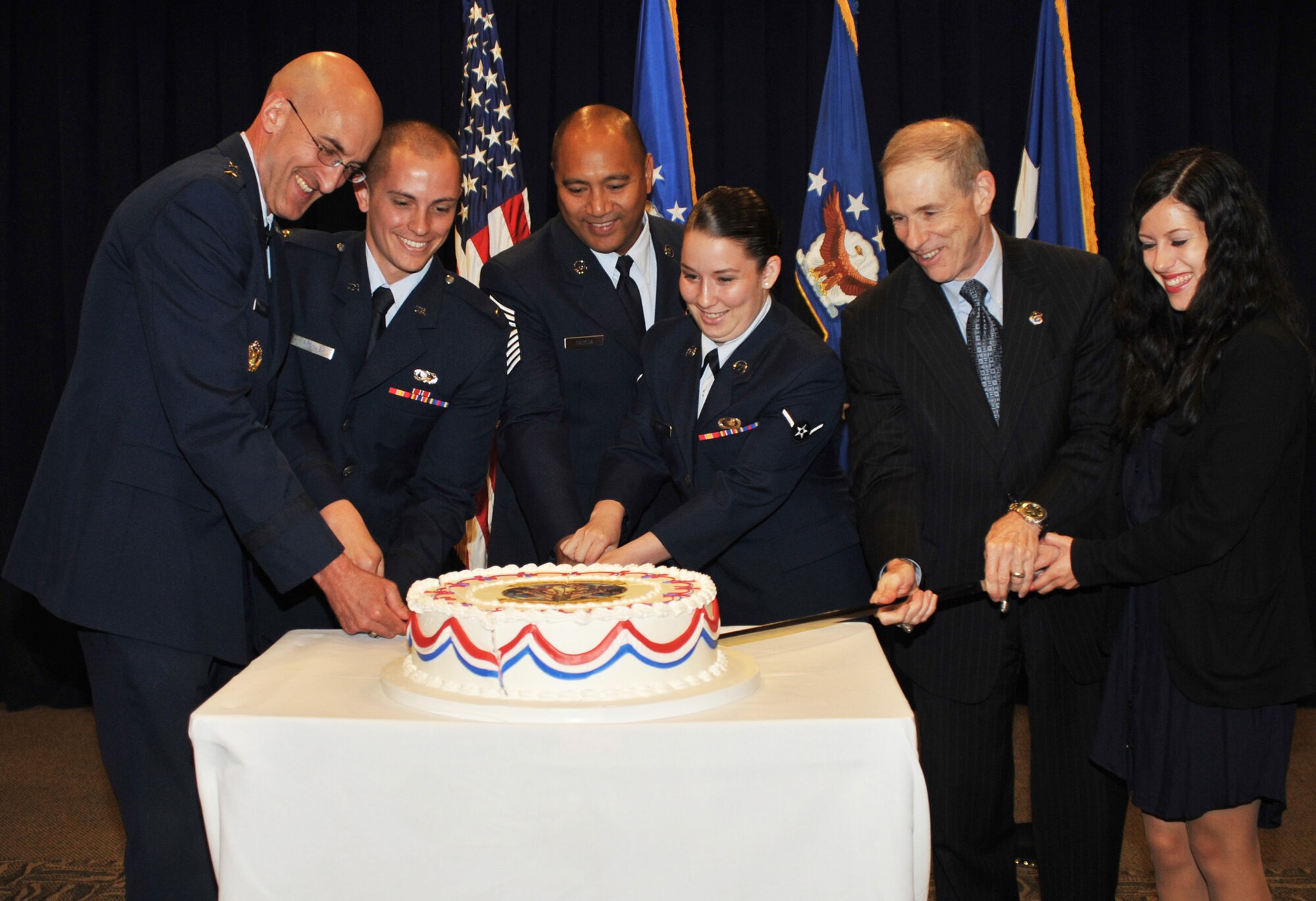 Major General Terrence Feehan, SMC vice commander; Chief Master Sergeant Jose Pascua; and Douglas Loverro, SMC executive director;  are joined by the base’s youngest officer, enlisted and civilian employee in cutting the ceremonial cake marking the Air Force’s birthday, Sept. 18. (Photo by Sarah Corrice)