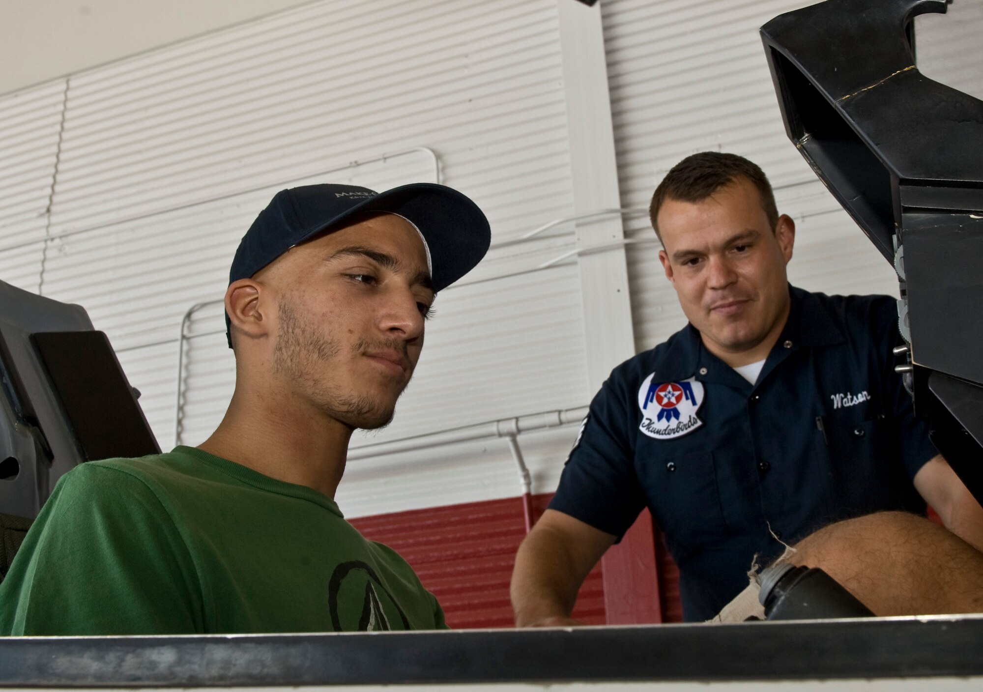 Georgios Kalevrosglou, Make-A-Wish recipient, sits inside a F-16 Fighting
Falcon simulator cockpit as Staff Sgt. Jarid Watson, USAF Aerial Demonstration team "Thunderbirds" public affairs craftsman, explains the functions of control panel Sept. 20, 2012 at Nellis Air Force Base, Nev.The Make-A-Wish Foundation worked in partnership with Nellis to fulfill Kalevrosglou's wish to be around jets and the men and women who work with them. (U.S. Air Force photo/Senior Airman Daniel Hughes)