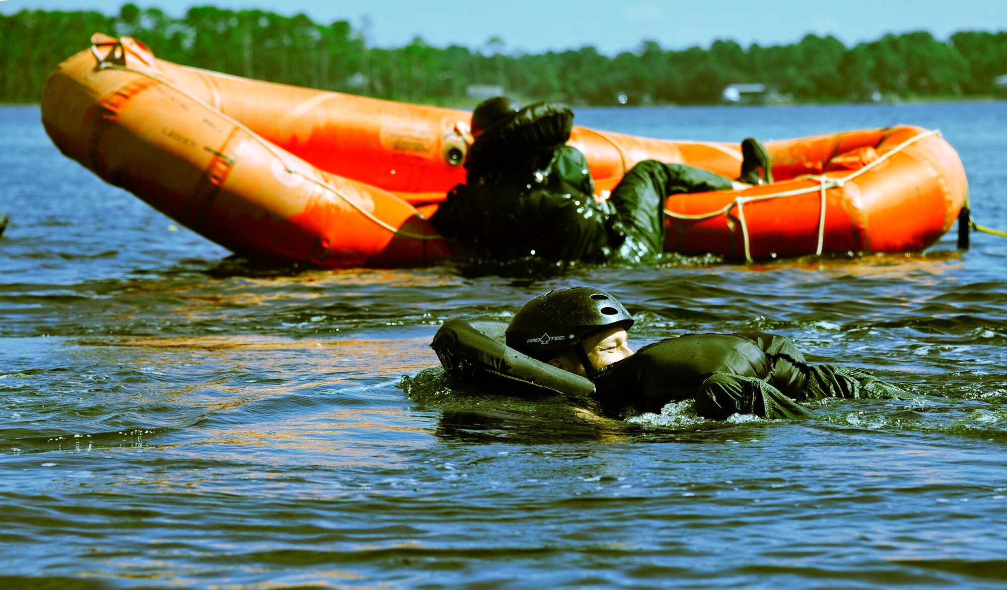 Jerry Miller, the 16th Electronic Warfare Squadron honorary commander, gets towed out while another honorary commander climbs aboard a raft during water survival training at Post’l Point, Sept. 28. Designed for training pilots in the use of water survival equipment after an ejection over the sea or an emergency landing, the exercises provide an interactive environment for community members to work with Airmen. The honorary commander program pairs civic leaders and wing leadership together to exchange ideas and educate civilians about Air Force life. The 53rd Wing currently has 11 honorary commanders. (U.S. Air Force photo/Randy Gon)