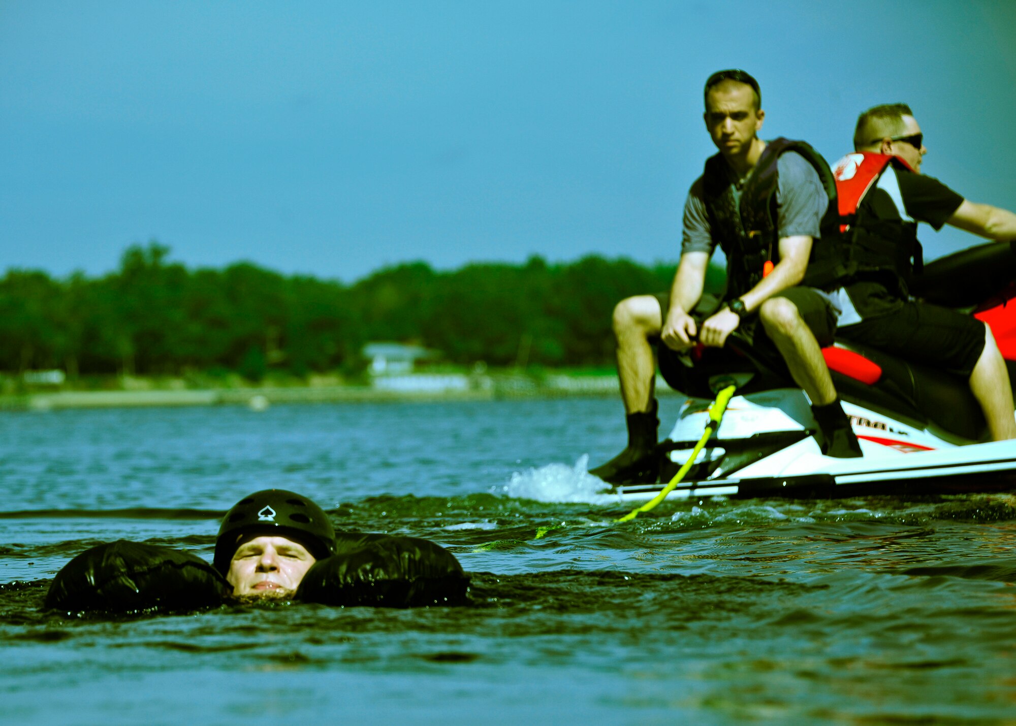 Dr. Eric Goldberg, the 513th Electronic Warfare Squadron honorary commander, is towed away from shore to simulate being drug by a parachute after a water landing during water survival training at Post’l Point, Sept. 28. Designed for training pilots in the use of water survival equipment after an ejection over the sea or an emergency landing, the exercises provide an interactive environment for community members to work with Airmen. The honorary commander program pairs civic leaders and wing leadership together to exchange ideas and educate civilians about Air Force life. The 53rd Wing currently has 11 honorary commanders. (U.S. Air Force photo/Randy Gon)