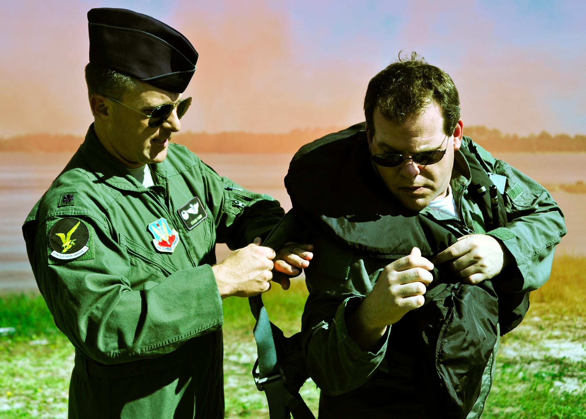 Lt. Col. Chad Fager, the 513 Electronic Warfare Squadron commander, assists his honorary commander, Dr. Eric Goldberg, during water survival training at Post’l Point, Sept. 28. Designed for training pilots in the use of water survival equipment after an ejection over the sea or an emergency landing, the exercises provide an interactive environment for community members to work with Airmen. The honorary commander program pairs civic leaders and wing leadership together to exchange ideas and educate civilians about Air Force life. The 53rd Wing currently has 11 honorary commanders. (U.S. Air Force photo/Randy Gon)