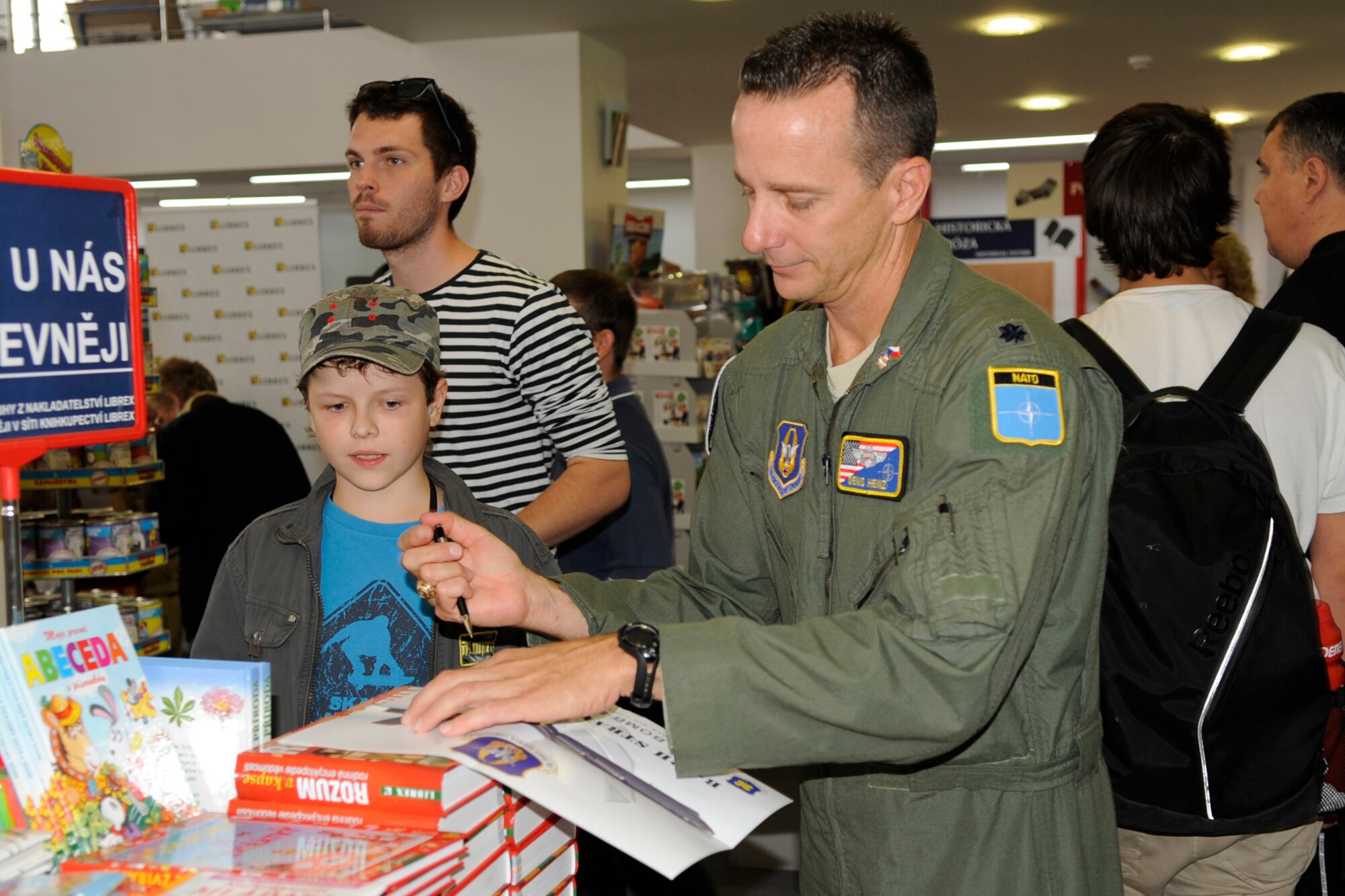 Lt. Col. Denis Heinz, the 343rd Bomb Squadron commander signs a picture of a B-52 Stratofortress for a boy during a speaking engagement at the Librex book store in Ostrava, Czech Republic Sept. 21, 2012. Members of the 307th Bomb Wing, along with other air show participants from other countries were asked to speak about their aircraft and military experience in a public forum while in Ostrava for NATO Days 2012. (U.S. Air Force photo by Senior Master Sgt. Jessica D’Aurizio/Released)
