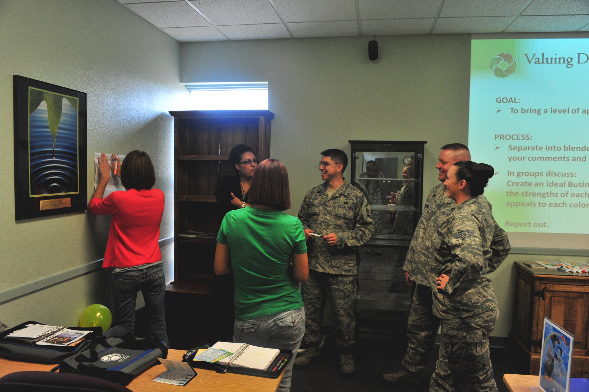 Attendees at the Cannon Key Spouse informative briefing interact with support service facilitators and instructors at Cannon Air Force, N.M., Sept. 28, 2012. The briefings educated future key spouses on how to communicate and guide military spouses in the right direction. (U.S. Air Force photo/Airman 1st Class Xavier Lockley)  
