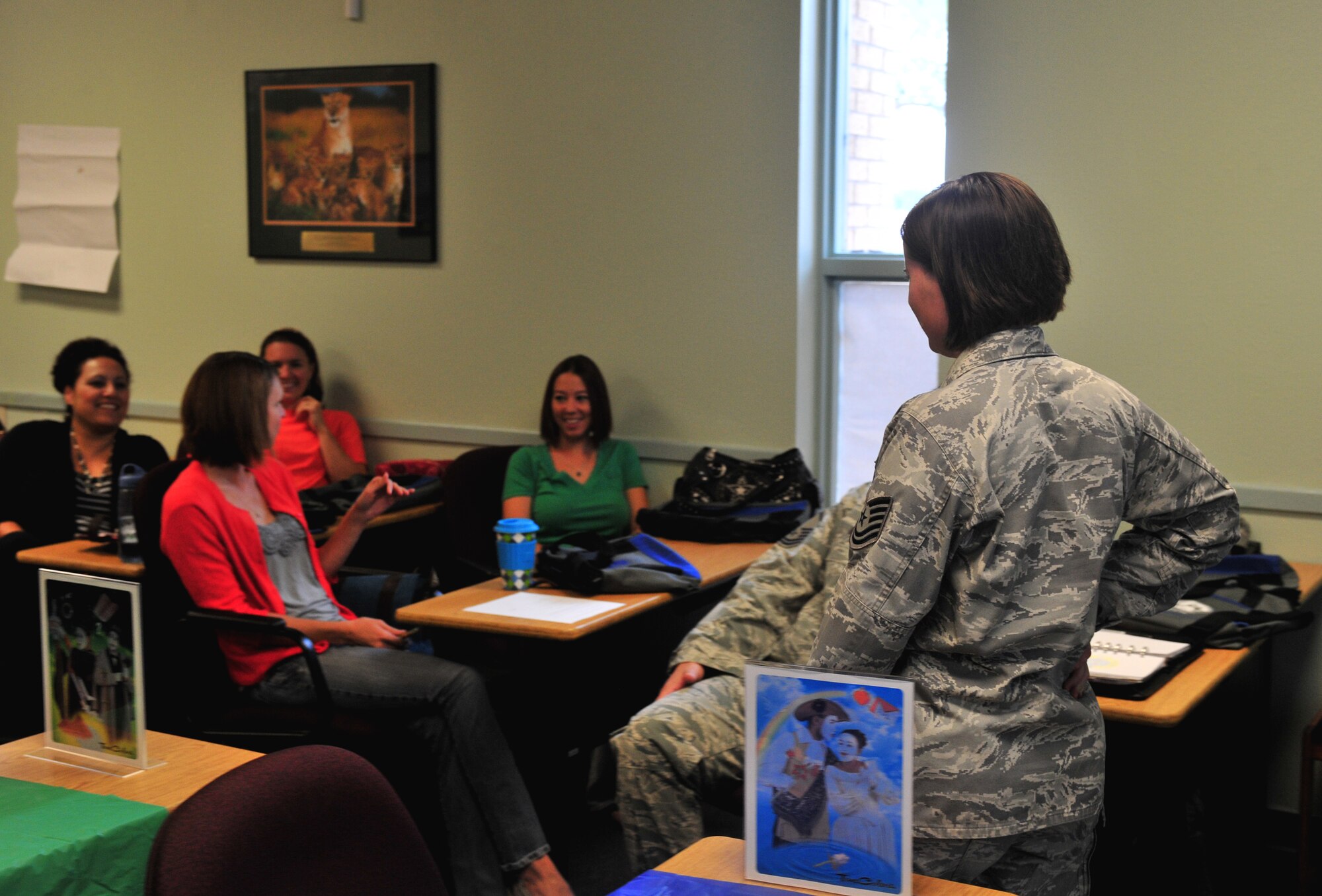U.S. Air Force Tech. Sgt. Melinda Morris, 27th Special Operations Wing Equal Opportunity advisor, interacts with attendees at the Cannon Key Spouse informative briefing at Cannon Air Force, N.M., Sept. 28, 2012. The briefings educated future key spouses on how to communicate and guide military spouses in the right direction. (U.S. Air Force photo/Airman 1st Class Xavier Lockley)  