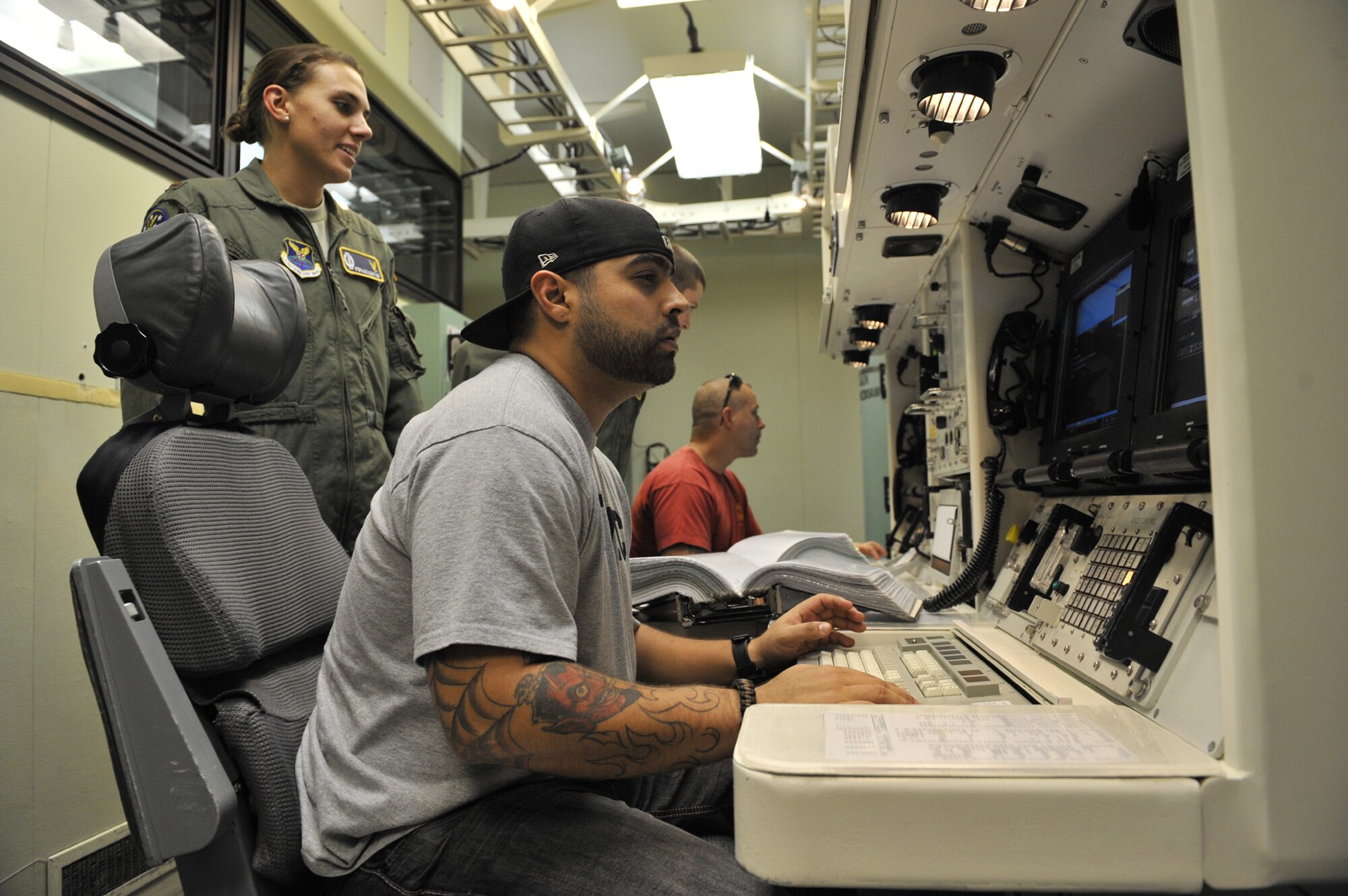 2nd Lt. Stephanie Guenther, 341st Operations Support Squadron ICBM instructor combat crew commander, left, shows Salvador Gonzalez the inside of the Missile Procedures Trainer on Sept. 25. Gonzalez and Daniel Gilyeat, both U.S. Marine Corps wounded veterans, visited Malmstrom Air Force Base as part of the American300 Gunners Tour. (U.S. Air Force photo/Airman 1st Class Katrina Heikkinen)