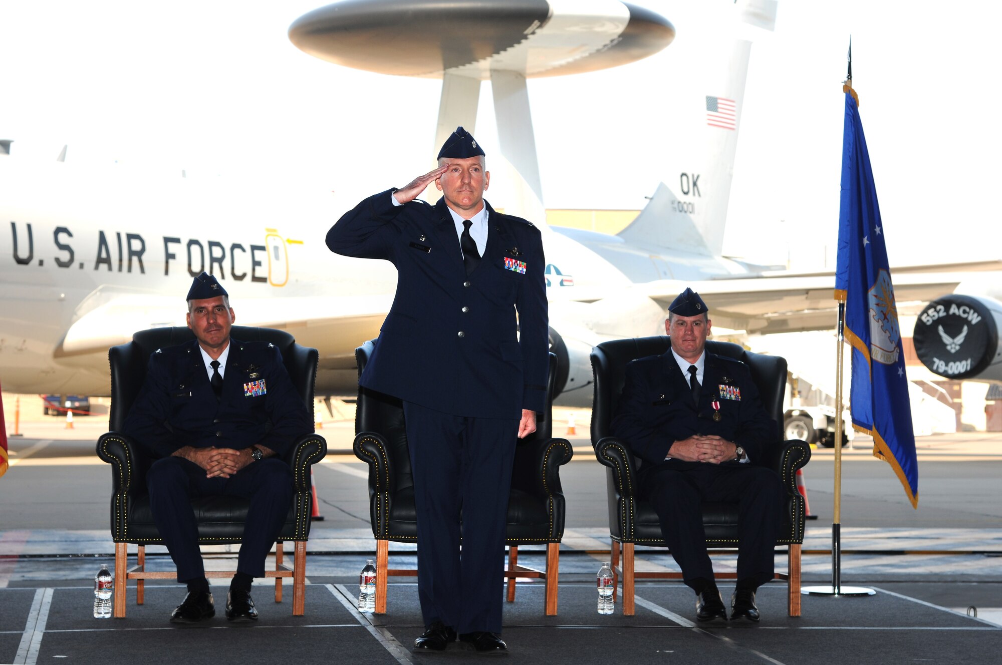 Lt. Col. Anthony Kleiger receives his first salute from members of the 965th Airborne Air Control Squadron shortly after assuming command of the squadron from Lt. Col. Peter Mykytyn, right, in a ceremony Sept. 20 in Bldg. 230, Dock 2. Colonel Kleiger had previously served as the Director of Operations for the 552nd Operations Support Squadron. Col. John Cooper, 552nd Operations Group commander, left, served as the presiding officer for the ceremony. (Air Force photo by David Faytinger)