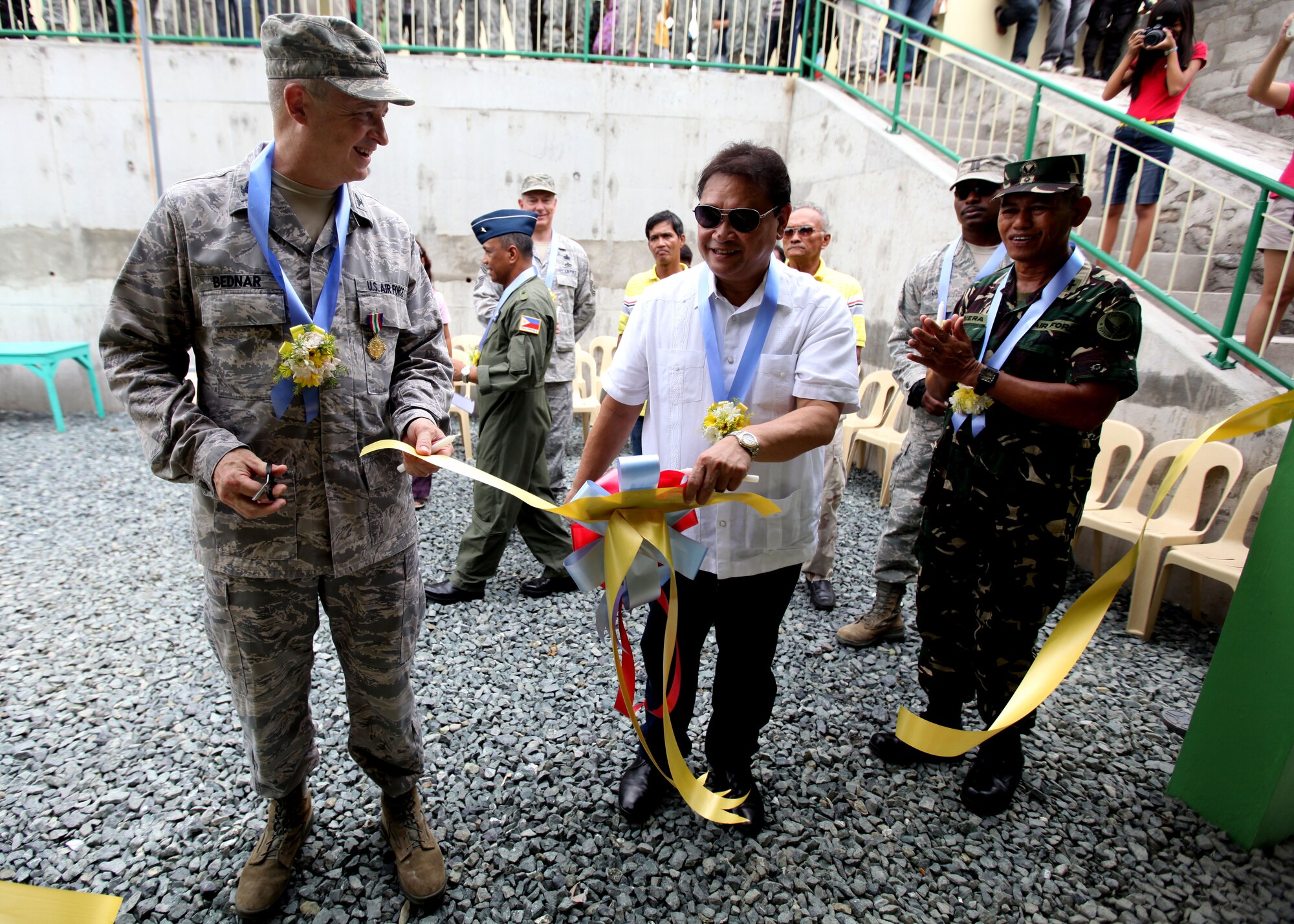 U.S. Air Force Col Mark Bednar stands with Mayor
Marino Morales after cutting the ribbon during a
dedication ceremony at Clark Air Force Base, Republic
of the Philippines on September 20, 2012. U.S. Air Force
Civil Engineering Squad 647 out of Joint Base Pearl
Harbor teamed up with the Republic of the Philippines
Air Force to build an addition onto a local schoolhouse
before dedicating it to the community. The U.S. military
and Republic of the Philippines military work together
to strengthen interoperability between the Philippine
and U.S. government. (U.S. Marine Corps photo by LCpl
Katelyn Hunter/Released).