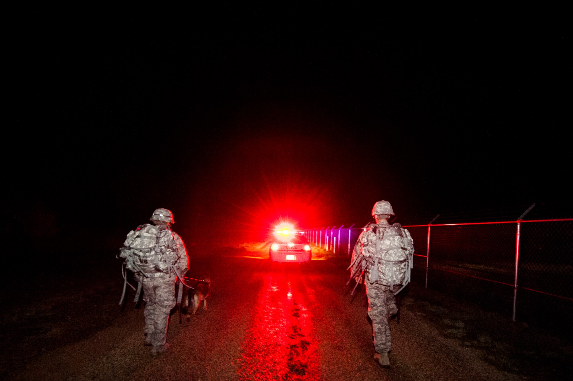 GOODFELLOW AIR FORCE BASE, Texas -- U.S. Air Force Senior Airman Stephen Rivera and Staff Sgt. Thomas Hubbard, 17th Security Forces Squadron dog handlers, walk their military working dogs during the Jacobson Memorial March, Sept. 28, 2012. The march was in honor of security forces member Airman 1st Class Elizabeth Jacobson, and marked the seventh anniversary of her death. Jacobson was the first security forces member as well as the first Air Force female to be killed in action in Operation Iraqi Freedom in 2005 by a roadside bomb. (U.S. Air Force photo/Airman 1st Class Michael Smith)