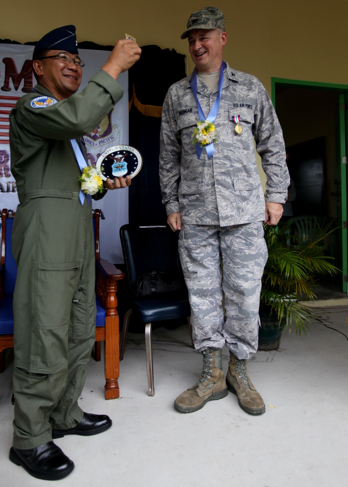 U.S. Air Force Col Mark Bednar presents Republic of the
Philippines Air Force MGen Ricardo Banayat with a
coin and engraved plate as a token of gratitude during a
dedication ceremony at Clark Air Force Base, Republic
of the Philippines on September 20, 2012. U.S. Air Force
Civil Engineering Squad 647 out of Joint Base Pearl
Harbor teamed up with the Republic of the Philippines
Air Force to build an addition onto a local schoolhouse
before dedicating it to the community. The U.S. military
and Republic of the Philippines military work together
to strengthen interoperability between the Philippine
and U.S. government. (U.S. Marine Corps photo by LCpl
Katelyn Hunter/Released).