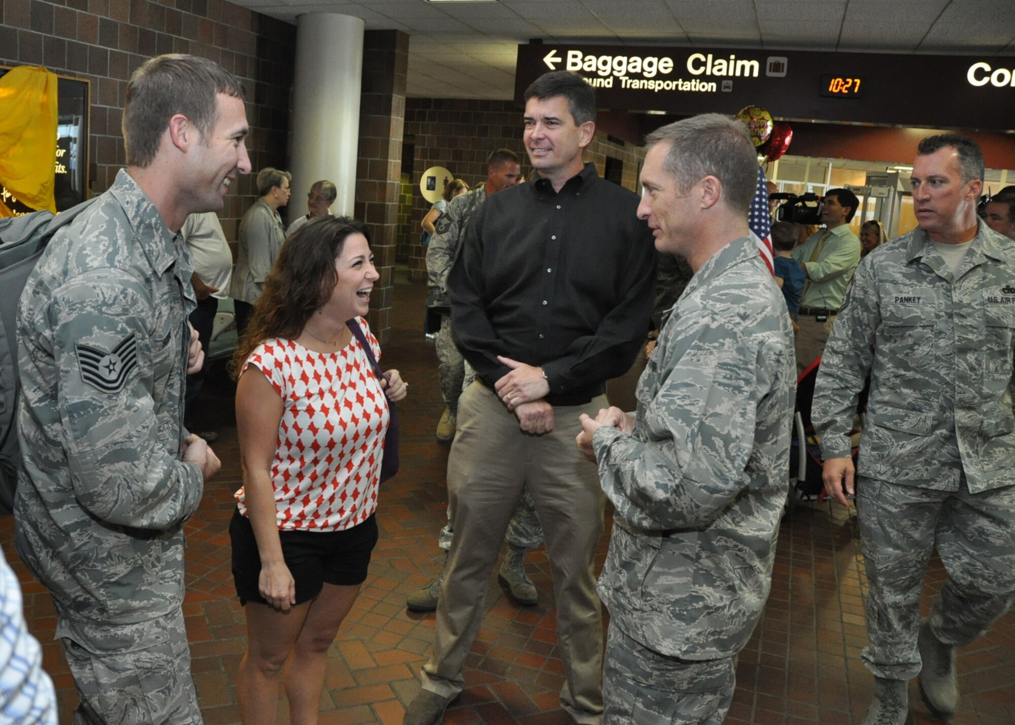 Tech. Sgt. Seth Soine and Penelope Jebeles are greeted by Col. James Fontanella at the Charleston International Airport Sept. 28, 2012. Soine was one of 22 Reserve Airmen who returned home after a six-month deployment to the Middle East. The Air Force Reserve Aerial Port members who deployed in March were responsible for cargo and passenger operations at their deployed locations. Soine is a special handling technician ramp services technician for the 81st Aerial Port Squadron and Fontanella is the 31th Airlift Wing commander at Joint Base Charleston, S.C. (U.S. Air Force Photo/Michael Dukes)