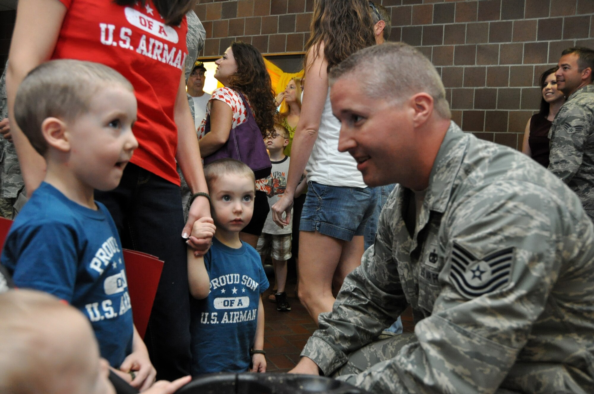 Tech. Sgt. Joe Speer enjoys a moment with his wife, Elizabeth and three sons Joseph, James Michael and Jediah, upon returning home from a six month deployment to the Middle East Sept. 28, 2012. The Air Force Reserve Aerial Port members who deployed in March were responsible for cargo and passenger operations at their deployed locations. Speer is a ramp services technician for the 81st Aerial Port Squadron at Joint Base Charleston, S.C. (U.S. Air Force Photo/Michael Dukes)
