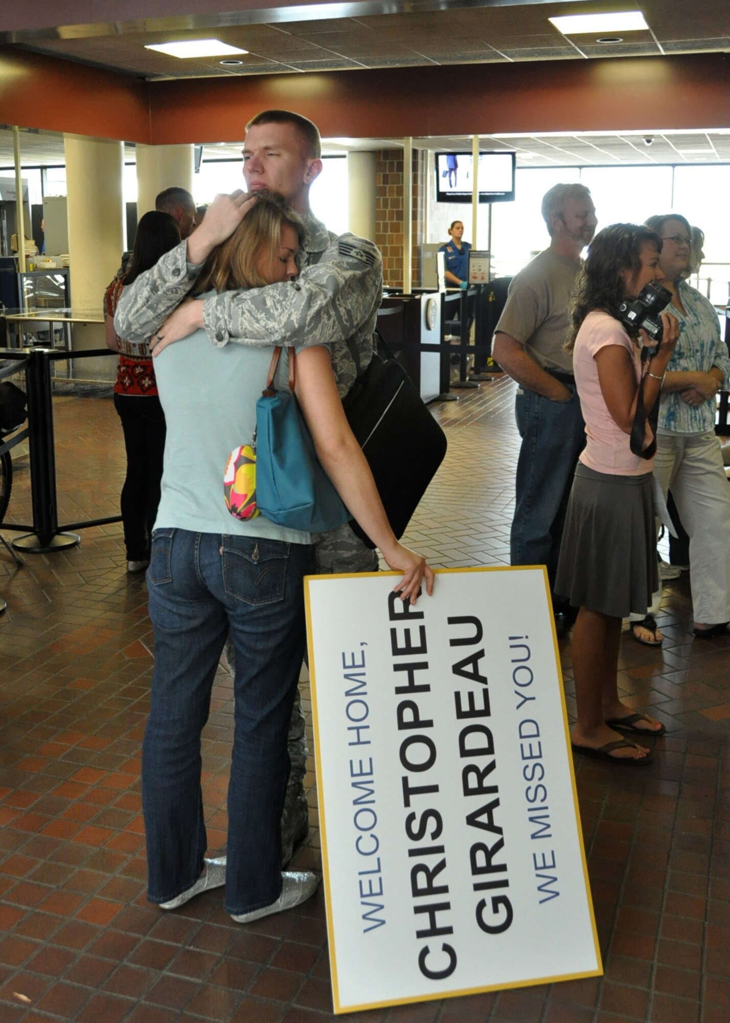 Staff Stg. Christopher Girardeau embraces his wife, Ellen, upon returning home from a six month deployment to the Middle East Sept. 28, 2012. The Air Force Reserve Aerial Port members who deployed in March were responsible for cargo and passenger operations at their deployed locations. Girardeau is a ramp services technician for the 81st Aerial Port Squadron at Joint Base Charleston, S.C. (U.S. Air Force Photo/Michael Dukes)