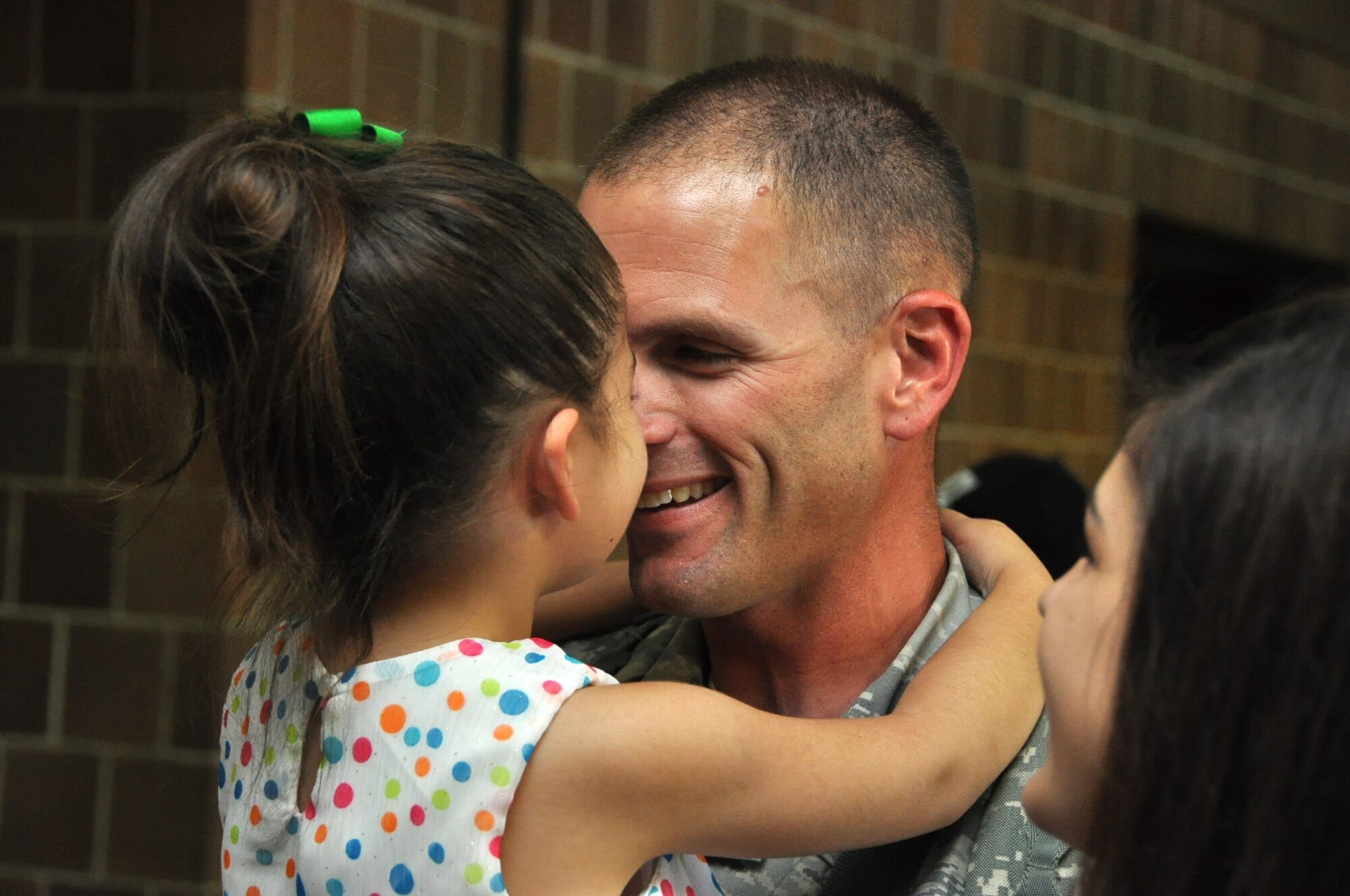 Senior Master Sgt. Jeff Lutz receives some much needed affection from his youngest daughter, Sophia, after arriving home from a six month deployment to the Middle East Sept. 28, 2012. The Air Force Reserve Aerial Port members who deployed in March were responsible for cargo and passenger operations at their deployed locations. Lutz is the air transportation superintendent for the 81st Aerial Port Squadron at Joint Base Charleston, S.C. (U.S. Air Force Photo/Michael Dukes)