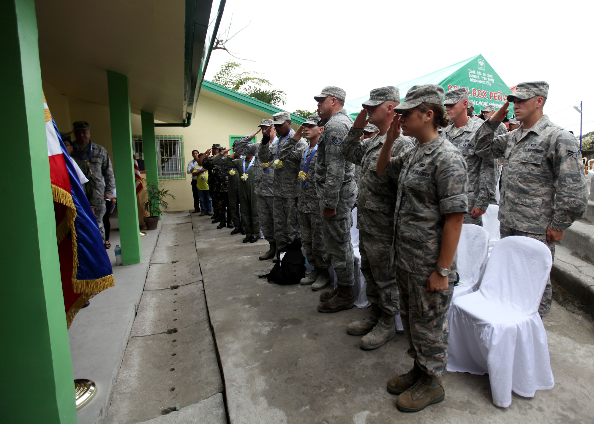 U.S. Airmen and Republic of the Philippines Airmen
salute during the Filipino National Anthem at a
dedication ceremony at Clark Air Force Base, Republic
of the Philippines on September 20, 2012. U.S. Air Force
Civil Engineering Squad 647 out of Joint Base Pearl
Harbor teamed up with the Republic of the Philippines
Air Force to build an addition onto a local schoolhouse
before dedicating it to the community. The U.S. military
and Republic of the Philippines military work together
to strengthen interoperability between the Philippine
and U.S. government. (U.S. Marine Corps photo by LCpl
Katelyn Hunter/Released).