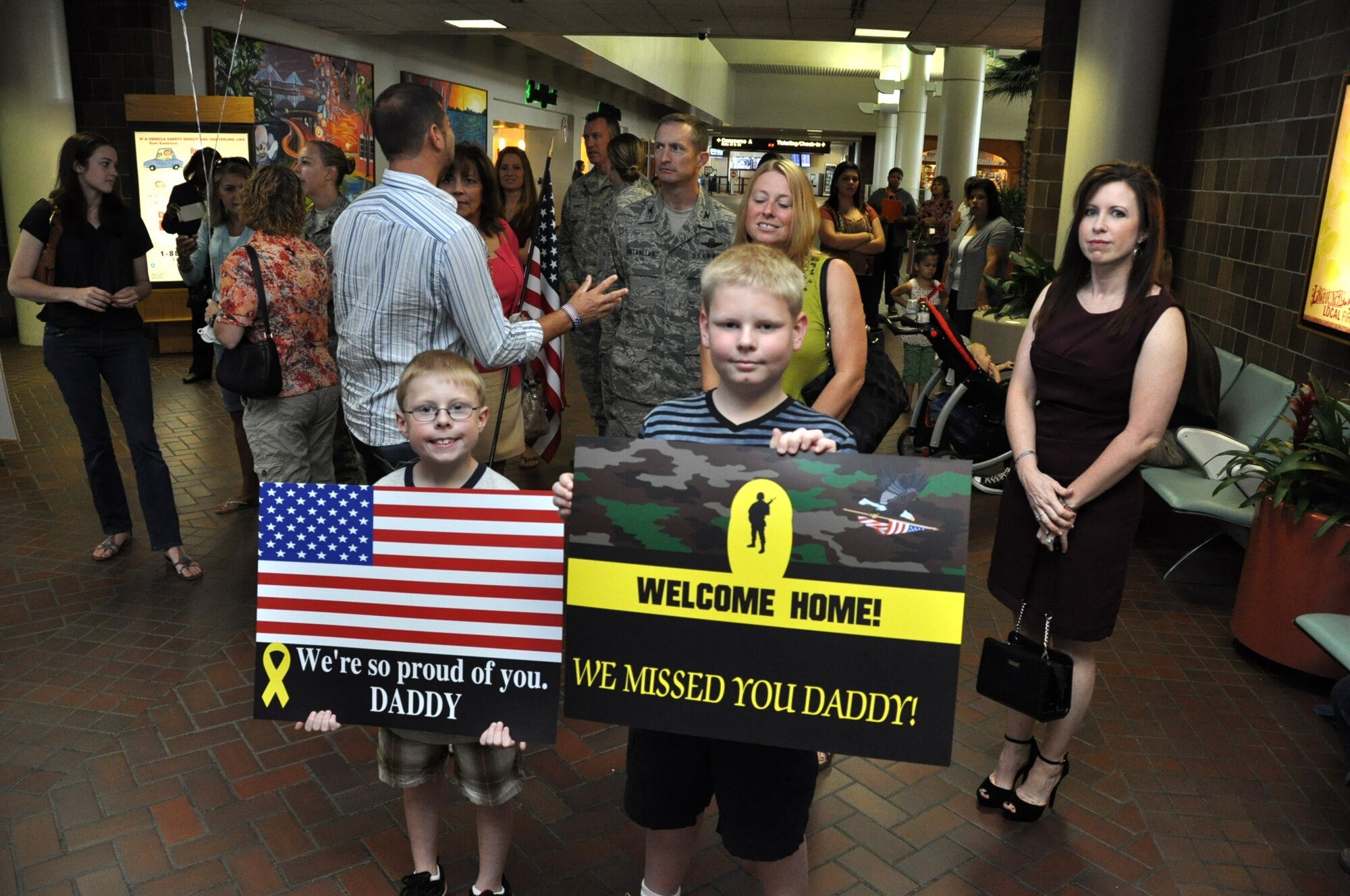 Master Sgt. Dave Korosi’s sons, Zachary and Caleb, stand ready for daddy to arrive home after his six-month deployment to the Middle East Sept. 28, 2012. The Air Force Reserve Aerial Port members who deployed in March were responsible for cargo and passenger operations at their deployed locations. Korosi is the ramp services team chief for the 81st Aerial Port Squadron at Joint Base Charleston, S.C. (U.S. Air Force Photo/Michael Dukes)