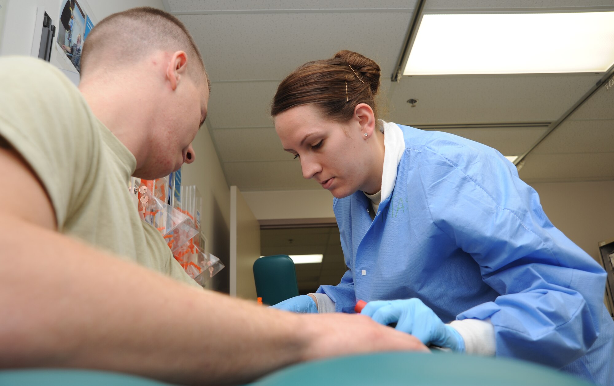 Airman 1st Class Tiffany Tobias, 22nd Medical Support Squadron medical laboratory apprentice, draws a blood sample from a patient for initial processing Sept. 27, 2012, McConnell Air Force Base, Kan. As a medical laboratory apprentice, Tobias is responsible for collecting, processing and reporting patient specimens and samples. She was recognized as the spotlight performer for the week of Sept. 24 to 28, 2012. (U.S. Air Force photo/Airman 1st Class Victor J. Caputo)