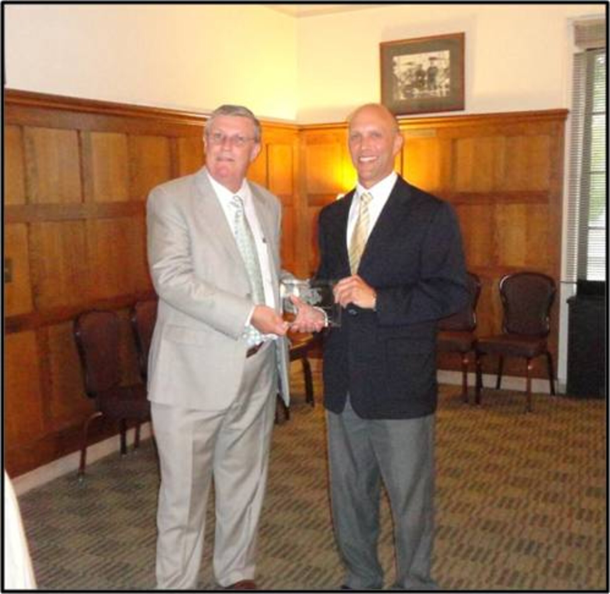 Dr. James Kearns presents Mr. John Schutte, 711th Human Performance Wing Technology Transfer Specialist, the award for Excellence in Technology Transfer at the Federal Laboratory Consortium Midwest Conference.
