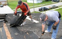 From left to right: Special Operations Command South servicemembers, Air Force Tech. Sgt. Greg Sowinski and Army Lt. Col. Stewart Mason take off old roof shingles from St. Matthews Baptist Church in Florida City, Fla., Sept. 18, as part of a weeklong project to help fix the deteriorated roof. SOCSOUTH, 482nd Fighter Wing, Homestead Job Corps and  several organizations were involved in helping repair the 60-year-old building as part of the community outreach program where military members assigned to Homestead Air Reserve Base, Fla., help residents in the surrounding areas. (Department of Defense photo by Sgt. 1st Class Alex Licea, Special Operations Command South Public Affairs Office)