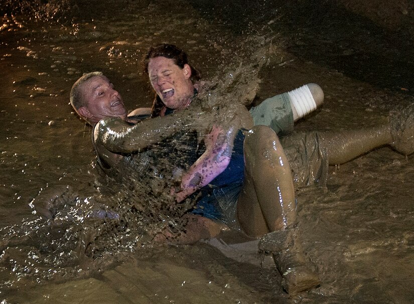 Army Sgt. James Nickelson and Angela Wright jump in a mud pit during a mud bogging event in Gore, Va., Sept. 15, 2012. Nickelson is with Battle Company, Warrior Transition Battalion, Bethesda, Md. (U.S. Air Force photo/Val Gempis)