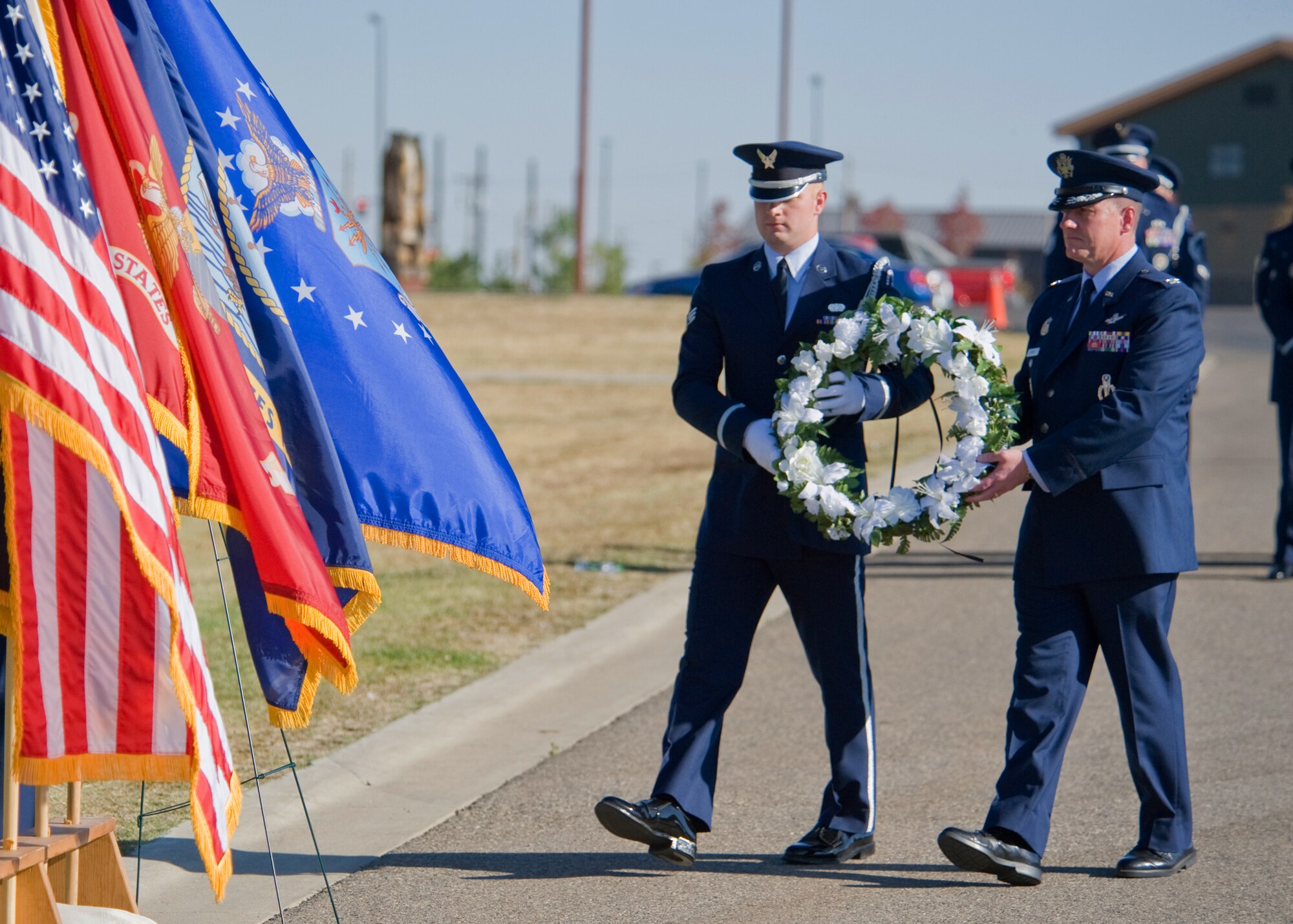 Col. Robert Stanley, 341st Missile Wing vice commander, right, and Senior Airman Malcolm Hunter II, 341st Civil Engineer Squadron electrical apprentice, carry a wreath in memory of all prisoners of war and persons missing in action during a POW/MIA ceremony held at the Medal of Honor Park on Sept. 21.  During the ceremony, members of Team Malmstrom participated in a retreat ceremony conducted by Malmstrom’s Honor Guard.  (U.S. Air Force photo/Beau Wade)