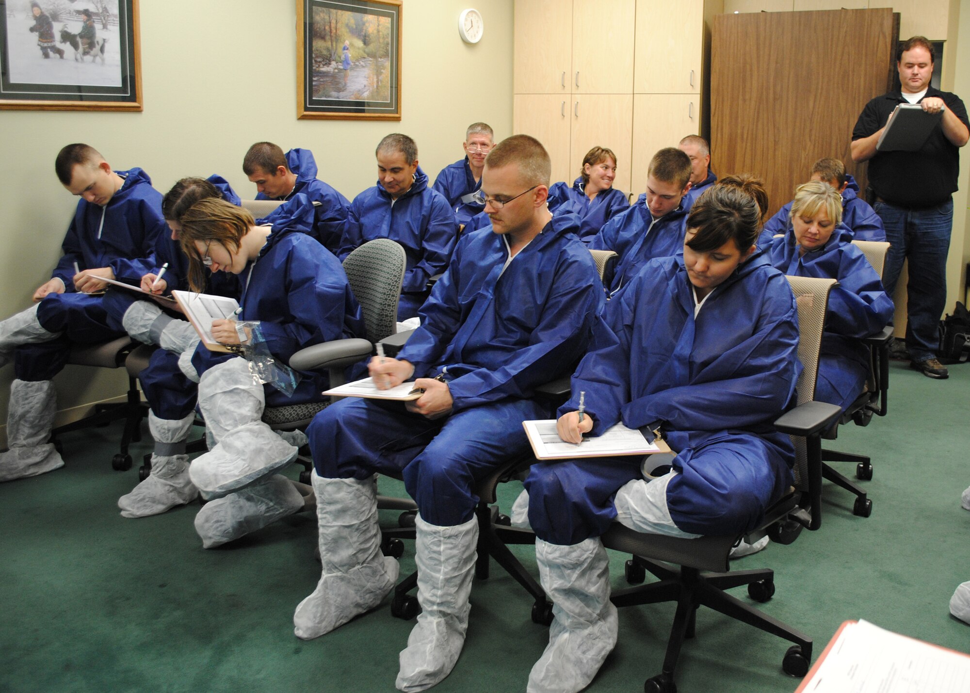 Team Malmstrom and Montana Air National Guard volunteers fill out a public health form at Great Falls City-County Health Department before they are given medical screenings and simulated post exposure prophylaxis during the exercise. (U.S. Air Force photo/Airman 1st Class Katrina Heikkinen)
