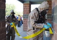 Airman 1st Class Zachary Torres, 341st Civil Engineer Squadron member, left, and Staff Sgt. Zachary Henry, 341st CES firefighter, set up security at the contamination site during the exercise. One of the objectives in the BDS Alert exercise was to properly isolate and secure the inner perimeter. Torres’ and Henry’s protective gear include respirators, rubber gloves and a level B suit, which is the highest level of respiratory protection necessary for a positive anthrax detection. (U.S. Air Force photo/Airman 1st Class Katrina Heikkinen)