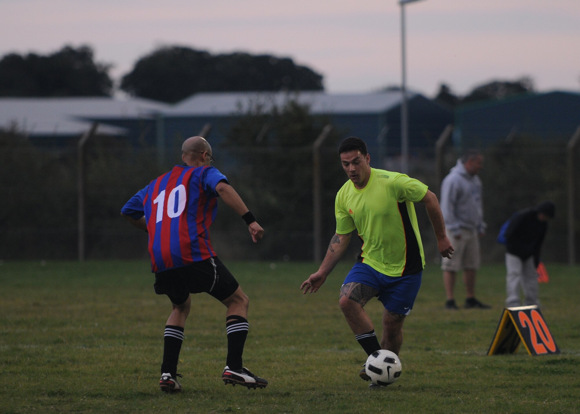 RAF MILDENHALL, England – Airman 1st Class Vincente Andrade, right, 100th Civil Engineer Squadron, dribbles the ball around a player from the 100th Logistics Readiness Squadron during an intramural soccer match at RAF Mildenhall, England, Sept. 27, 2012. (U.S. Air Force photo/Tech. Sgt. Neal X. Joiner)