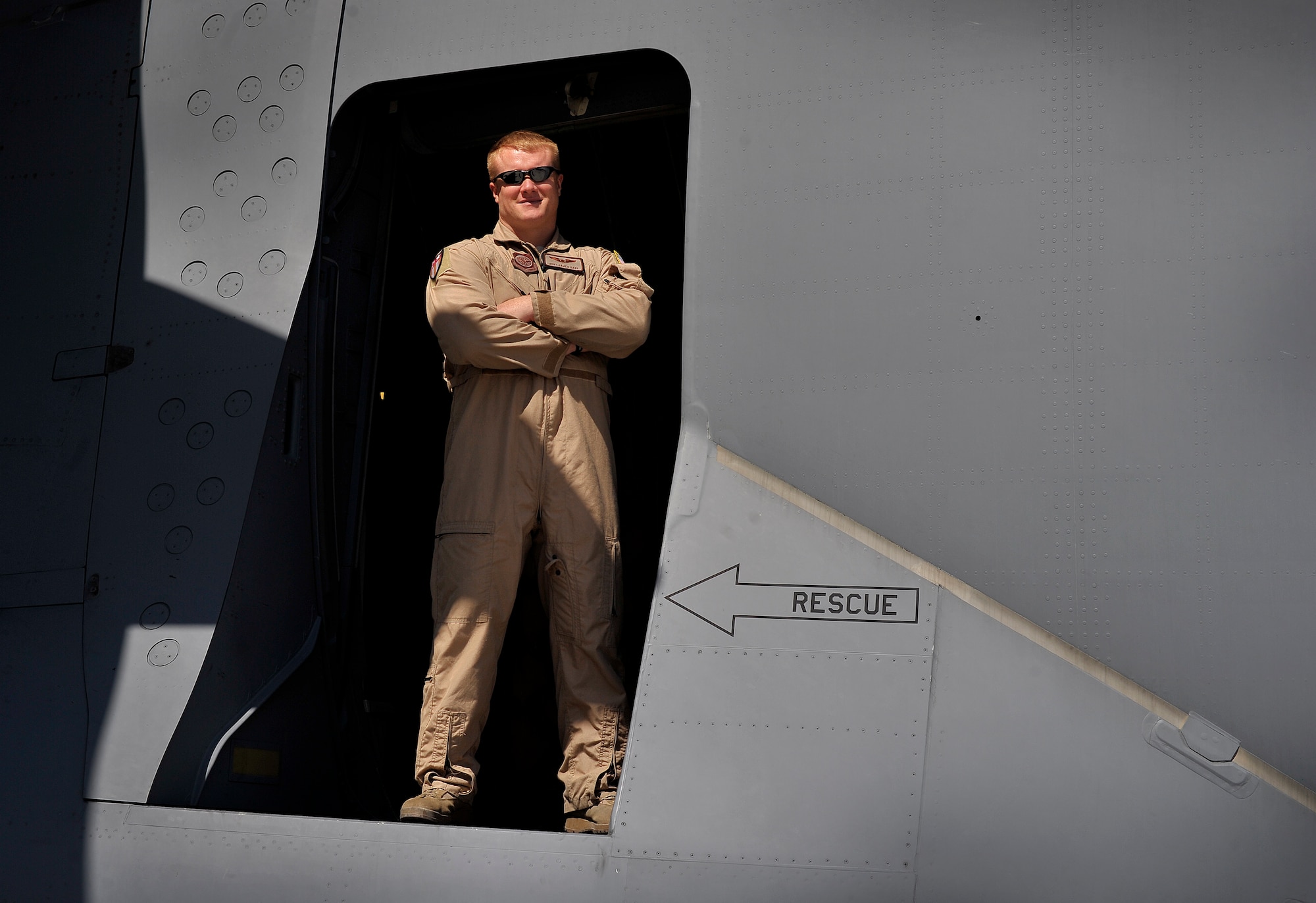Staff Sgt. James Harp, currently deployed with the 817th Expeditionary Airlift Squadron, Transit Center at Manas, Kyrgyzstan, smiles in the door of a C-17 Globemaster III. Harp is one of several loadmasters contributing to redeployment operations in Afghanistan. Harp heavily relied upon by the squadron as a loadmaster evaluator and has been in the Air Force for six and a half years. (U.S. Air Force photo/Staff Sgt. Clay Lancaster/ Released) 
