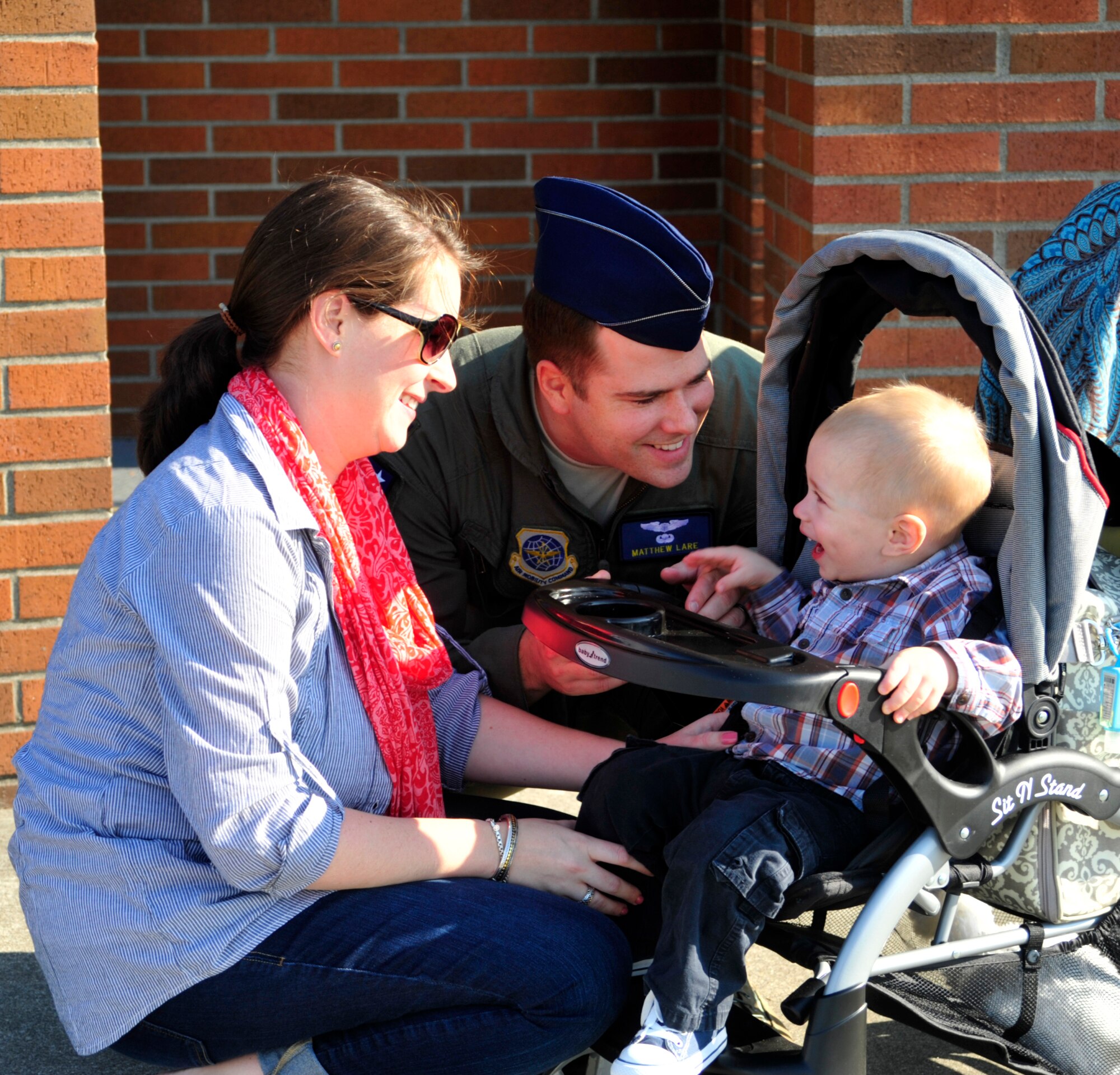 Capt. Matthew Lare, 7th Airlift Squadron member, says "goodbye" to his wife and son in front of the squadron at Joint Base Lewis-McChord, Wash., Sept. 26, 2012, before departing for a 60-day deployment in support of Operations Enduring Freedom, New Dawn, Odyssey Dawn and Combined Joint Task Force-Horn of Africa. More than 65 Airmen from the 7th AS departed for this deployment. (U.S. Air Force photo/Master Sgt. Todd Wivell) 