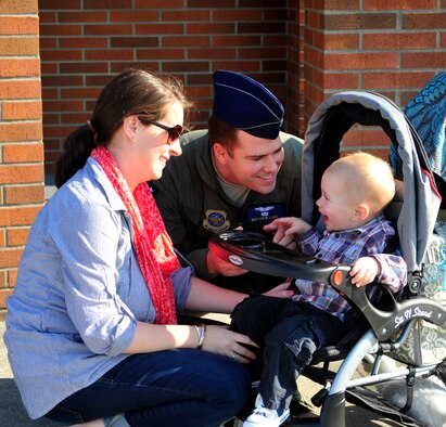 Capt. Matthew Lare, 7th Airlift Squadron member, says "goodbye" to his wife and son in front of the squadron at Joint Base Lewis-McChord, Wash., Sept. 26, 2012, before departing for a 60-day deployment in support of Operations Enduring Freedom, New Dawn, Odyssey Dawn and Combined Joint Task Force-Horn of Africa. More than 65 Airmen from the 7th AS departed for this deployment. (U.S. Air Force photo/Master Sgt. Todd Wivell) 