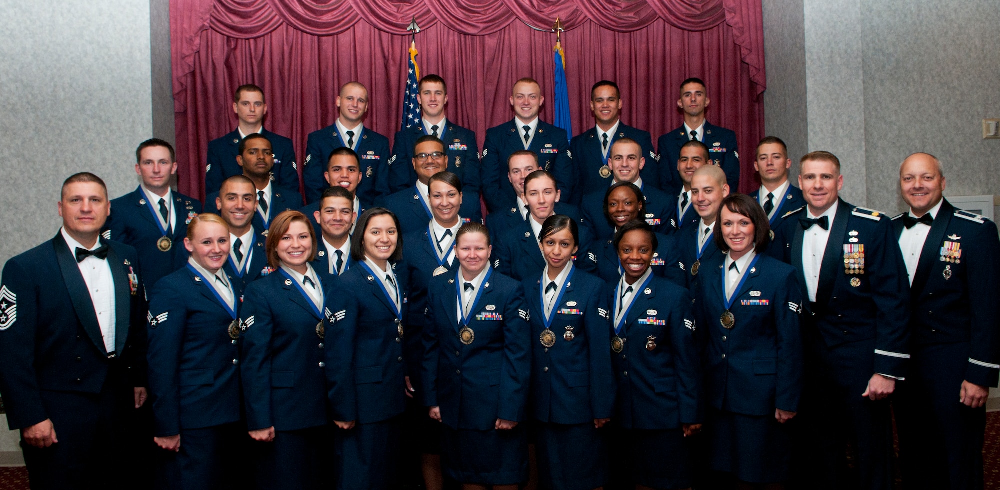Col. Christopher Coffelt, 90th Missile Wing commander, Maj. Chad Ellsworth, 90th Logistics Readiness Squadron commander, and Chief Master Sgt. Michael Garrou, 90th MW command chief, pose with Airman Leadership School class 12G graduates shortly before their graduation ceremony. (U.S. Air Force photo by Airman 1st Class Jason Wiese)
