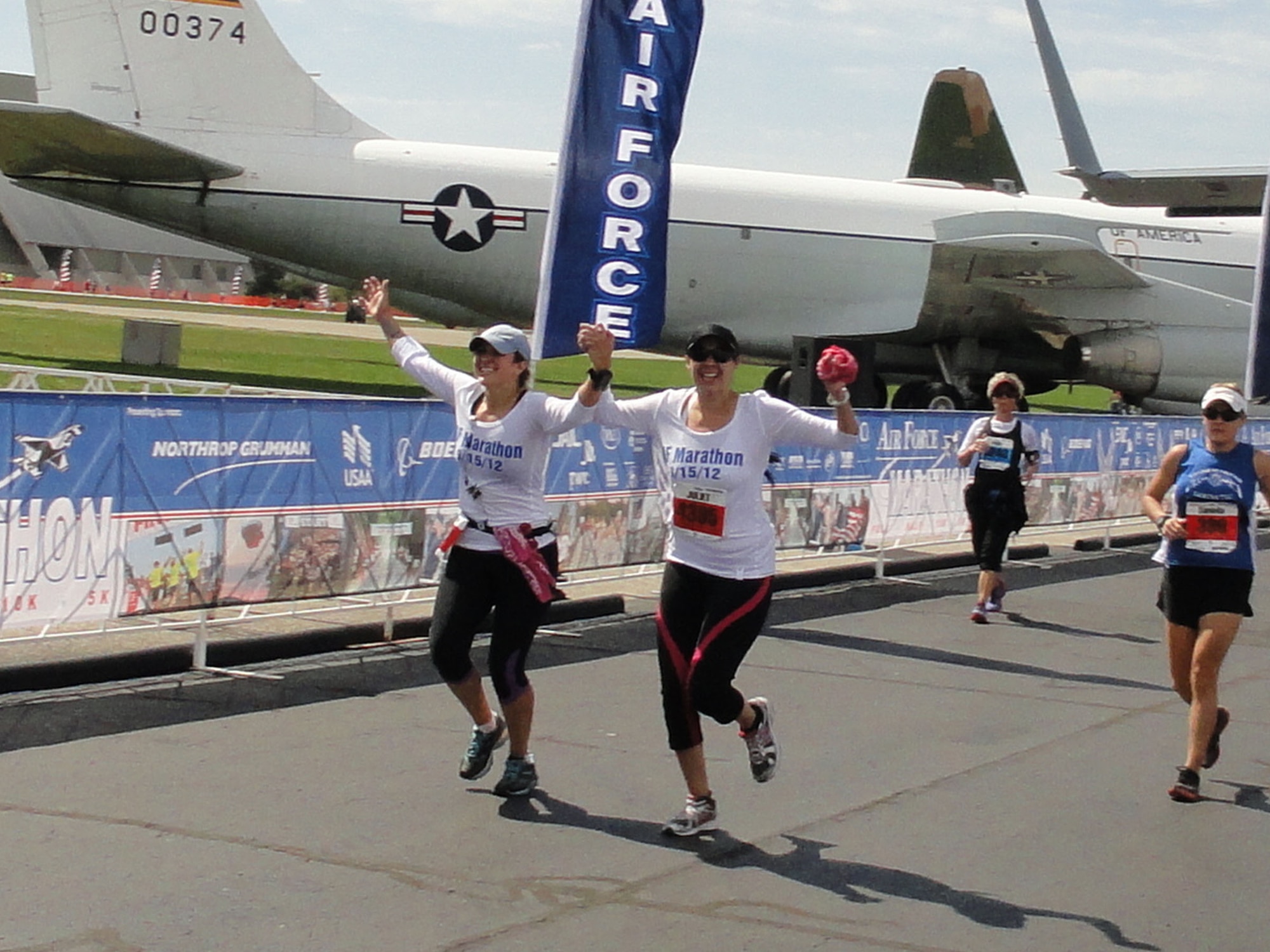 WRIGHT-PATTERSON AIR FORCE BASE, Ohio – From left to right; Master Sgt. Jacqueline Duarte, 548th Operations Support Squadron, Beale Air Force Base, Calif., and Juliet Valenzuela, an Air Force veteran now living in Florida, cross the finish line of the 2012 Air Force Marathon in  4 hours, 40 minutes Sept. 15. Both are the siblings of Tech. Sgt. Joseph Valenzuela, 445th Aeromedical Evacuation Squadron, who crossed the finish line in 4:15. (Courtesy photo)


