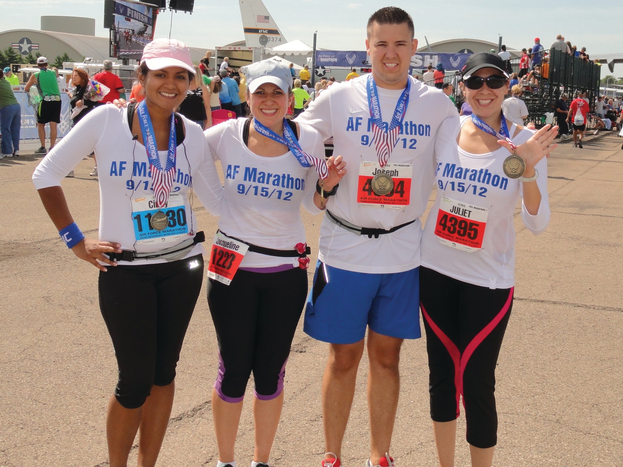 WRIGHT-PATTERSON AIR FORCE BASE, Ohio - From left to right; Cindy Valenzuela, Jackie Duarte, Joseph Valenzuela and Juliet Valenzuela, show off their medals after completing the 2012 Air Force Marathon. Cindy, Joseph’s wife, received her medal for completing the half marathon. (Courtesy photo)