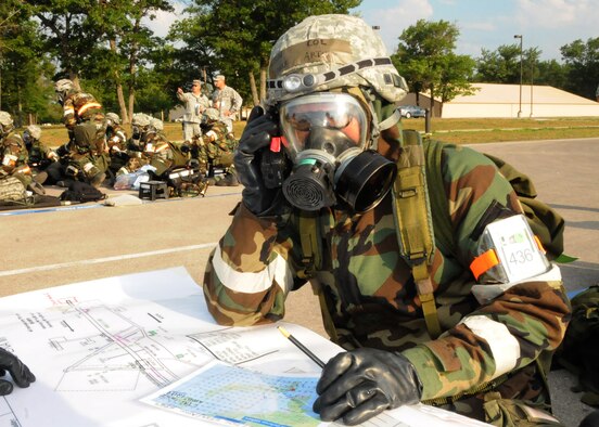 Colonel (Col) Arthur Floru, Commander of the 143d Airlift Wing (AW), Rhode Island Air National Guard (RIANG) and the simulated 125th Air Expeditionary Wing located at Alpena Combat (CRTC), Michigan, keeps operational control of the Wing from a simulated bunker during a simulated attack. The 125th AEW is comprised of members from the 143d AW, the 107th AW of Niagara, New York, and the 914th AW also of Niagara, NY. The units have joined forces for their Operational Readiness Inspection (ORI). National Guard Photo by Tech Sgt Jason Long (RELEASED)