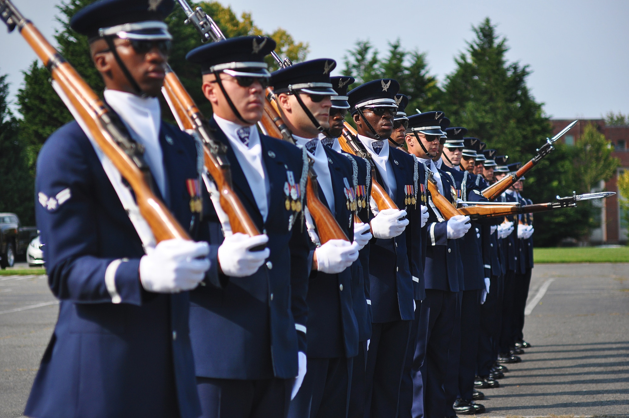 Members of the U.S. Air Force Honor Guard drill team stand in formation as they perform rapid movements with their M-1 Garand rifles, creating a wave effect down the line, Sept. 24, 2012, at Joint Base Lewis-McChord, Wash. The team stopped at JBLM on their tour around the country and performed many demonstrations around the area. (U.S. Air Force photo/Staff Sgt. Sean Tobin)