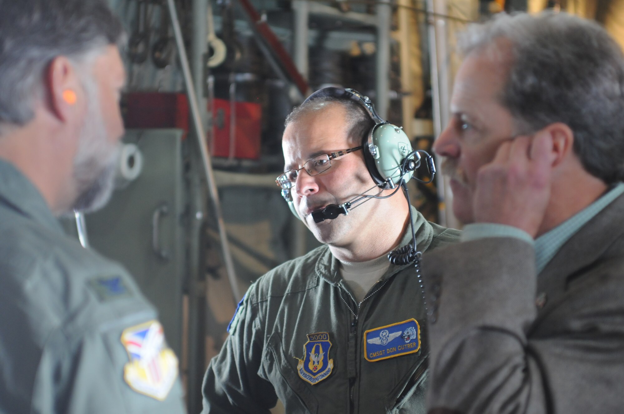 YOUNGSTOWN AIR RESERVE STATION, Ohio -- U.S. Air Force Reserve Senior Master Sgt. Don Cutrer, a chief loadmaster, discusses his reserve duties with civic leaders aboard a C-130 H Hercules orientation flight. The flight was part of a tour for Boy Scouts of America leadership and community members belonging to judicial offices held at YARS, Sept. 26, designed to build advocacy for the Air Force Reserve and inform attendees on the mission and capabilities of the 910th Airlift Wing. U.S. Air Force photo by Mr. Eric M. White.