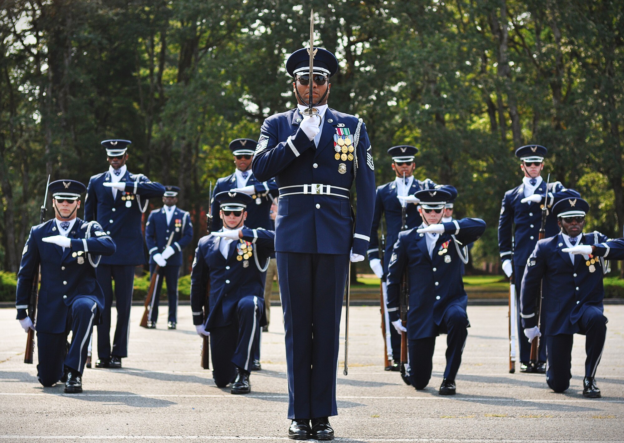 Members of the U.S. Air Force Honor Guard drill team pause briefly after performing their final movements during a performance, Sept. 24, 2012, at Joint Base Lewis-McChord, Wash. The team stopped at JBLM on their tour around the country and performed many demonstrations around the area. (U.S. Air Force photo/Staff Sgt. Sean Tobin)