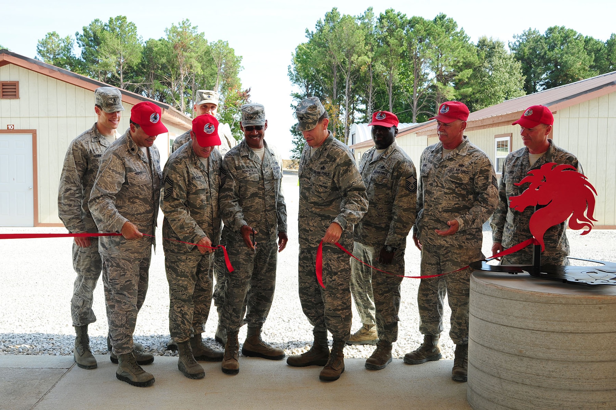 Left to right, U.S. Air Force Lt. Col. Marty Hughes, 556th Rapid Engineer Deployable Heavy Operational Repair Squadron Engineers Squadron commander, Lt. Col. D.J. Katzer, 633rd Civil Engineer commander, and Col. Korvin Auch, 633rd Air Base Wing commander, cut the ribbon during the opening ceremony of Raptor Town at Langley Air Force Base, Va., Sept. 27, 2012. The ceremony was held to mark the last day RED HORSE personnel from various bases were temporarily-on-duty at Langley, constructing Raptor Town. (U.S. Air Force photo by Staff Sgt. Ashley Hawkins/Released)