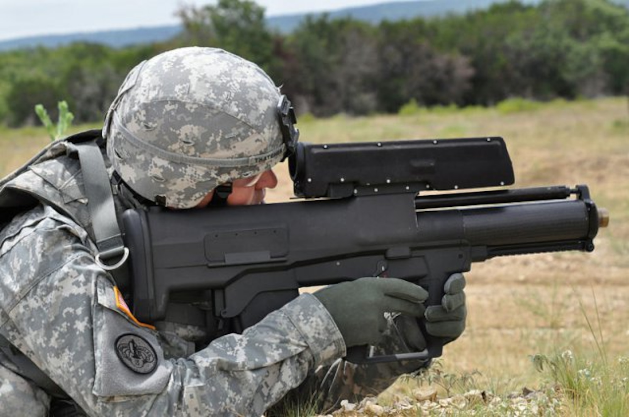 The XM25 CDTE fires 25 mm grenades that are set to explode in mid-air at or near the target. A laser rangefinder in the weapon is used to determine the distance to the target. The user can manually adjust the detonating distance by up to 10 feet (3.0 m) shorter or longer; the XM25 automatically transmits the detonating distance to the grenade in the firing chamber. The grenade tracks the distance it has traveled by the number of spiral rotations after it is fired, then detonates at the proper distance to produce an air burst effect. (U.S. Army Courtesy Photo/Released)
