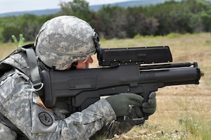 The XM25 CDTE fires 25 mm grenades that are set to explode in mid-air at or near the target. A laser rangefinder in the weapon is used to determine the distance to the target. The user can manually adjust the detonating distance by up to 10 feet (3.0 m) shorter or longer; the XM25 automatically transmits the detonating distance to the grenade in the firing chamber. The grenade tracks the distance it has traveled by the number of spiral rotations after it is fired, then detonates at the proper distance to produce an air burst effect. (U.S. Army Courtesy Photo/Released)