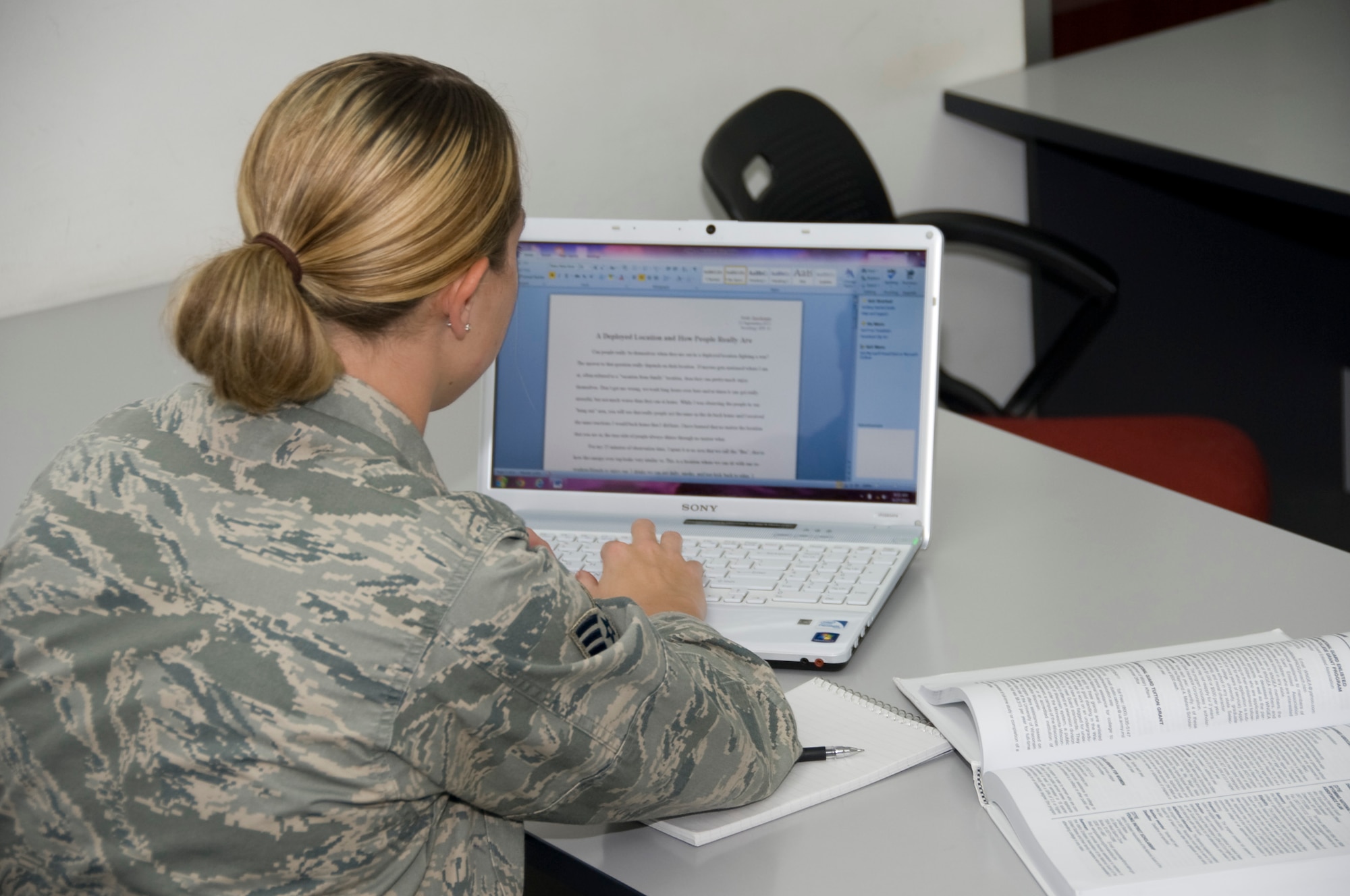 Senior Airman Emily Barchenger, 37th Expeditionary Bomb Squadron intelligence analyst, puts the finishing touches on her sociology paper at the BPC Education center Sept. 27, 2012. Barchenger recently became the 400,000 Airman to complete at Community College of the Air Force degree. She obtained an Associate Degree of Science in Intelligence Studies and Technology. Barchenger is deployed from  Ellsworth Air Force Base, S.D. (U.S. Air Force photo/Senior Airman Bryan Swink)