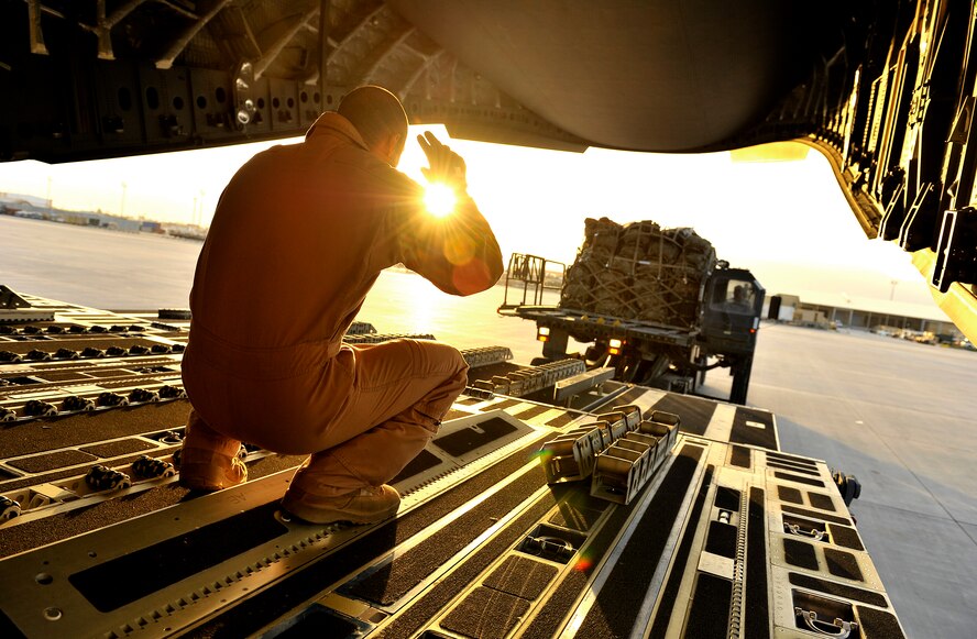 U.S. Air Force Staff Sgt. Jason Livingston, C-17 Globemaster III loadmaster, guides cargo into position in order to depart for a mission in Southwest Asia, Sept. 9, 2012. The U.S. military is currently redeploying combat forces in certain areas of Afghanistan in order to transition control to the Afghan National Security Forces.(U.S. Air Force photo/Staff Sgt. Clay Lancaster/ Released) 
