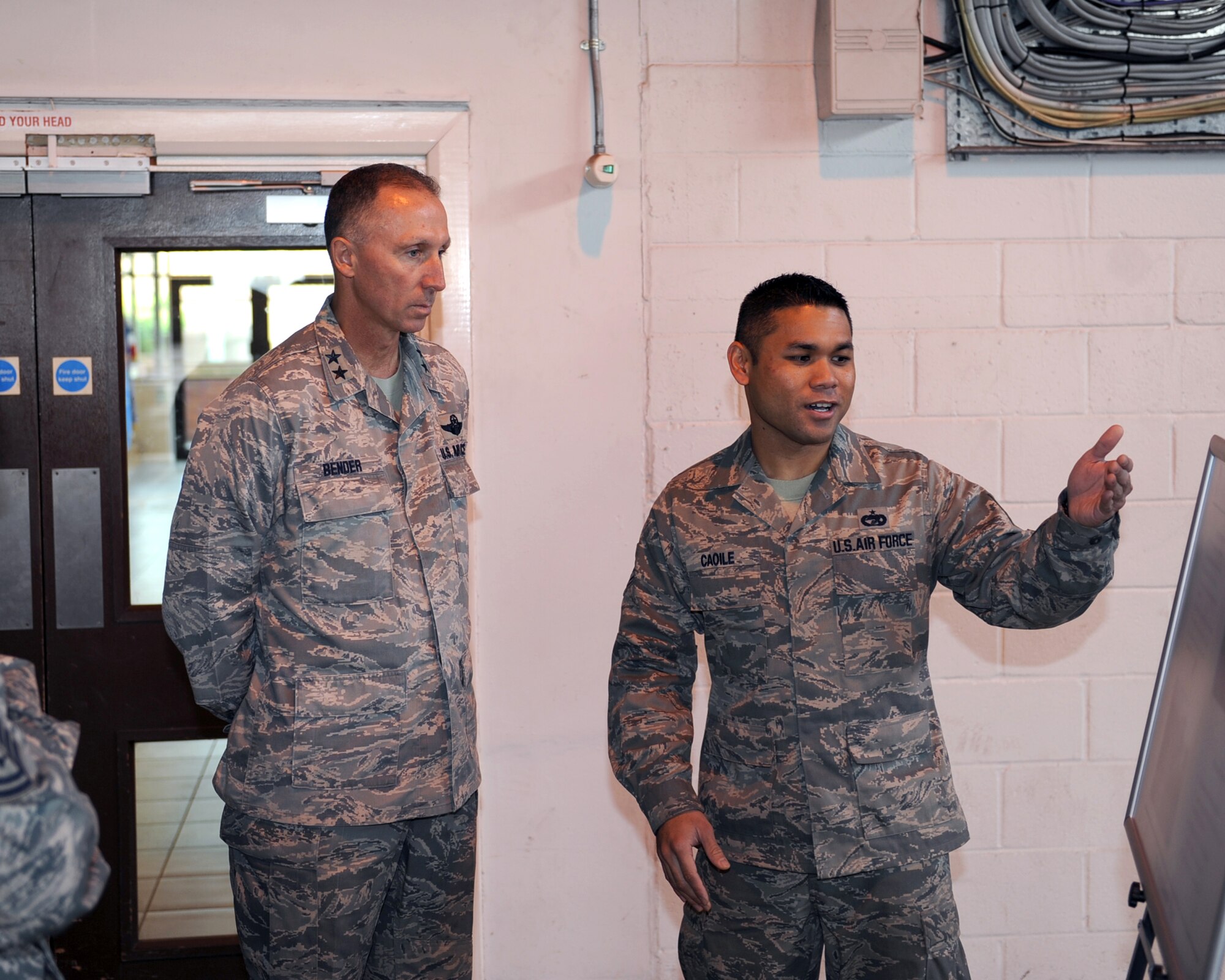 Tech. Sgt. Jaymhar Caoile, 727th Air Mobility Squadron Special Handling supervisor, briefs Maj. Gen. William Bender, Expeditionary Center commander on the capabilities of the 727th AMS, here, Sept. 27, 2012. The general visited the 727th AMS as a part of a visit to England to more effectively utilize the assets that he commands. (U.S. Air Force photo/ 2nd Lt. Christopher Mesnard)
