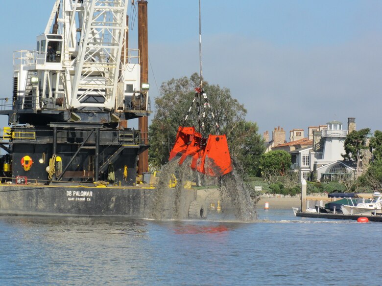 R.E. Staite’s dredge Palomar works in tight spaces alongside waterfront homes in Newport Harbor to remove sediment from channels, restoring safe navigation for boats using the harbor.