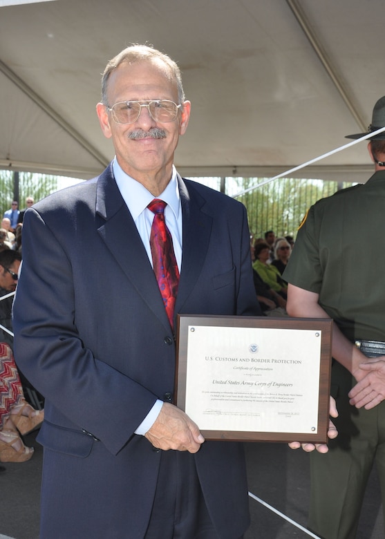 Larry Flatau, the U.S. Army Corps of Engineers Los Angeles District's Interagency and International Services program branch chief, pauses after receiving a Certificate of Appreciation from the Customs and Border Protection Agency during the Sept. 18 dedication ceremony for the Brian A. Terry Border Patrol Station in Naco, Ariz. The District constructed the station which was named for the Border Patrol agent killed in the line of duty Dec. 15, 2010.