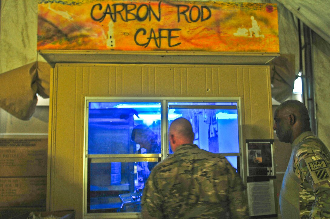 U.S. Army Command Sgt. Maj. Frank A. Grippe, left, command senior enlisted leader for U.S. Central Command, and Command Sgt. Maj. Edd Watson, 3rd Infantry Division and Regional Command South command sergeant major, enjoy some chow at the Carbon Rod Cafe after conducting a foot patrol in the Panjwai district of southern Afghanistan, Sept. 22, 2012. 