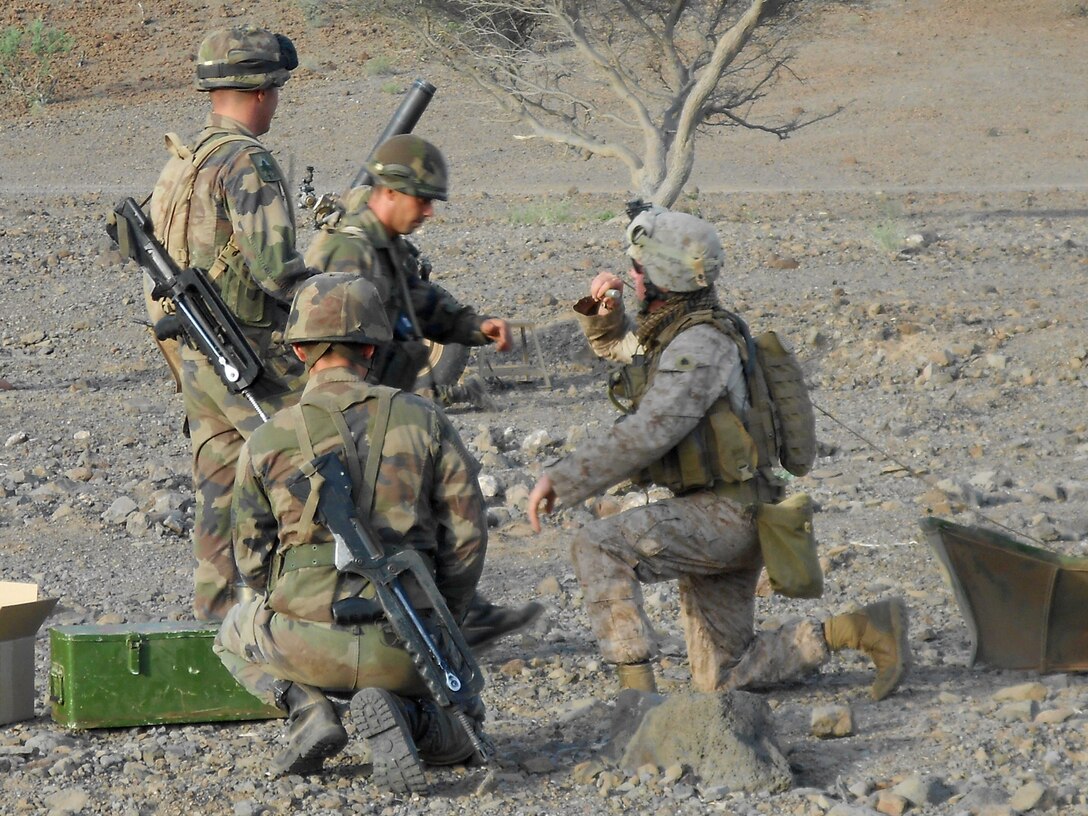 DJIBOUTI (Aug. 27, 2012) – Sgt. Ralph Pfeil, a section chief with India Battery, Battalion Landing Team 1st Battalion, 2nd Marine Regiment, 24th Marine Expeditionary Unit, rehearses gun drills with French Marines prior to conducting a bilateral live-fire training event in Djibouti, Aug. 27, 2012. Both nations spent Aug. 25-27 strengthening alliances and discussing tactics and procedures for the U.S. Marine Corps version of the French mortar, the M-327 120 mm Expeditionary Fire Support System, or EFSS. The 24th MEU, along with the Iwo Jima Amphibious Ready Group, is currently deployed to the U.S. Central Command and 5th Fleet areas of responsibility serving as a theater reserve providing support for maritime security operations and theater security cooperation efforts. (Courtesy photo by U.S. Marine Corps)